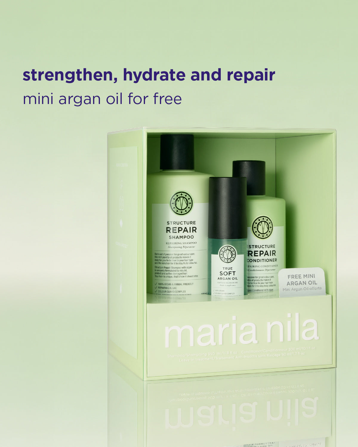 Maria Nila hårvårdsset i en ljust grön box, med en schampoflaska, en balsamflaska och ett litet gratis mini Argan Oil-paket, med reklamtext ovanför på en matchande ljust grön bakgrund.