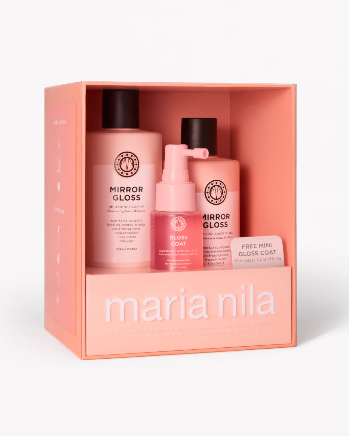 Maria Nila hårvårdsset i en persikofärgad box, som innehåller två Mirror Gloss-flaskor och en Gloss Coat-pumpflaska, på en vit bakgrund.