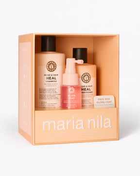 Maria Nila Head & Hair Heal-presentset i en persikofärgad box, som innehåller en schampoflaska, en balsamflaska och en mini Gloss Coat.