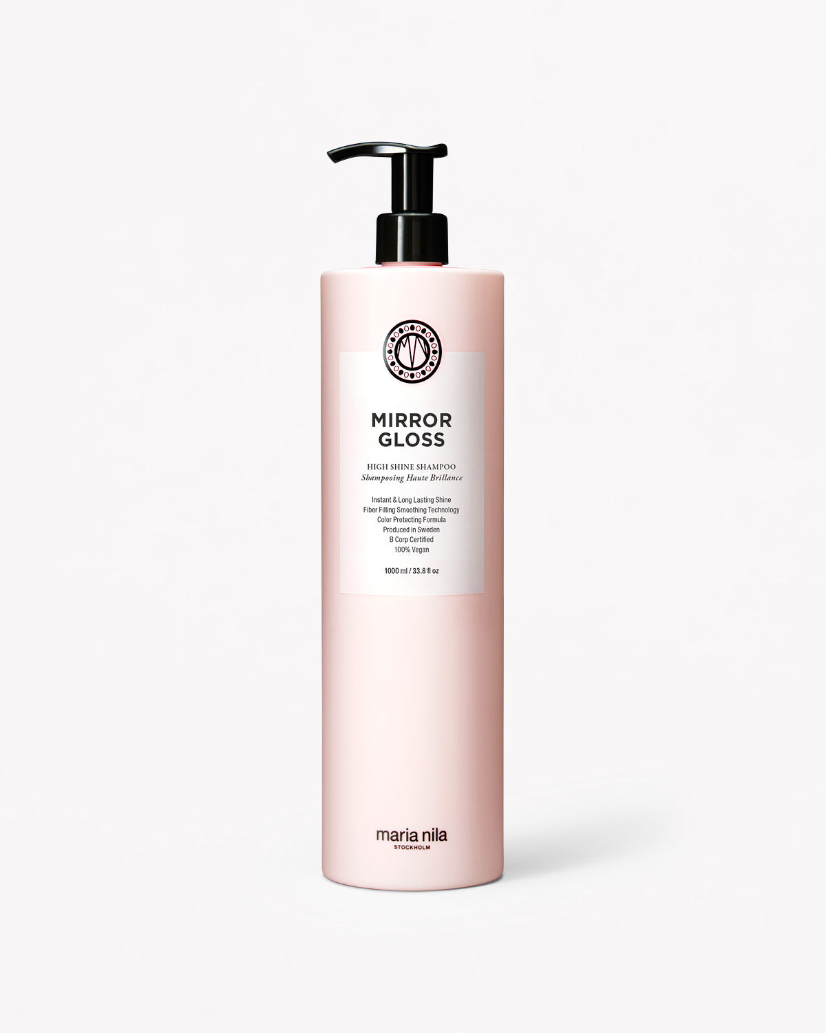 Ljusrosa literflaska med svart pump, Mirror Gloss Shampoo etikett med svart text.
